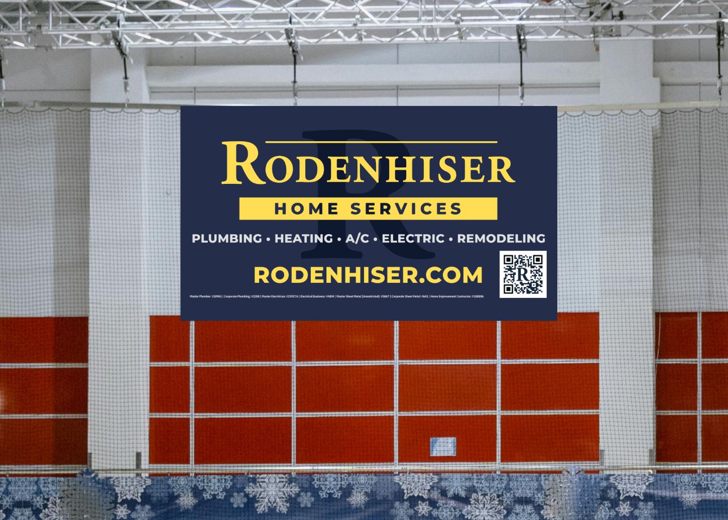 A banner hanging in a hockey rink displaying an ad for a local home services company.